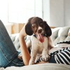 a woman and a dog on the couch